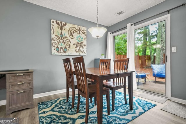 2959 Pritchards Mill Trl, Douglasville, GA 30135 - dining area with wood finished floors, baseboards, and a textured ceiling