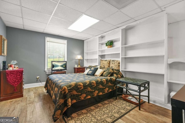 2959 Pritchards Mill Trl, Douglasville, GA 30135 - bedroom featuring wood finished floors, a paneled ceiling, and baseboards