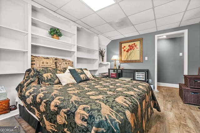 2959 Pritchards Mill Trl, Douglasville, GA 30135 - bedroom with wood finished floors, a paneled ceiling, and baseboards