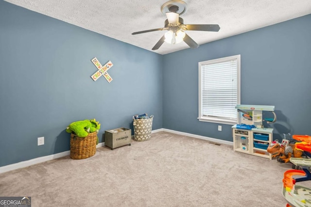 2959 Pritchards Mill Trl, Douglasville, GA 30135 - game room with a ceiling fan, carpet flooring, a textured ceiling, and baseboards