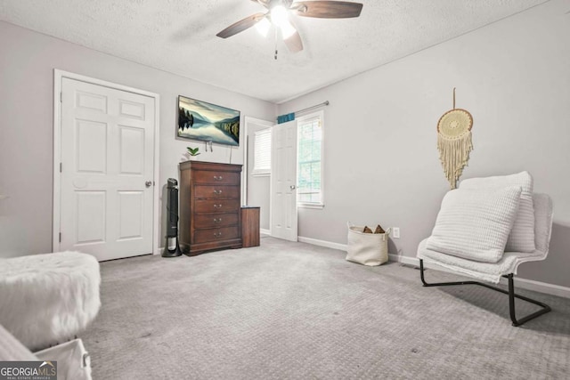 2959 Pritchards Mill Trl, Douglasville, GA 30135 - sitting room with a textured ceiling, ceiling fan, carpet floors, and baseboards