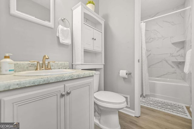 2959 Pritchards Mill Trl, Douglasville, GA 30135 - full bathroom featuring toilet, vanity, shower / bathtub combination with curtain, wood finished floors, and baseboards