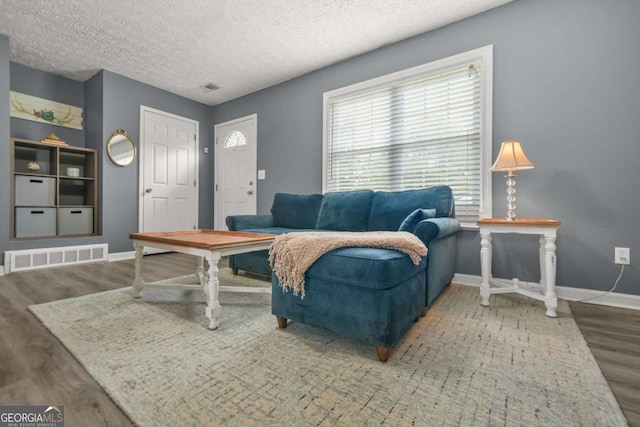 2959 Pritchards Mill Trl, Douglasville, GA 30135 - living room featuring wood finished floors, a textured ceiling, and baseboards
