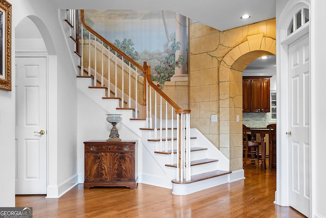 160 Torrey Pines Ct, Newnan, GA 30265 - stairs featuring arched walkways, wood finished floors, recessed lighting, and baseboards
