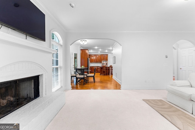 160 Torrey Pines Ct, Newnan, GA 30265 - living area with ornamental molding, arched walkways, carpet, a fireplace, and baseboards