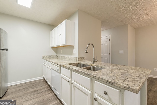 3151 Kingswood Gln, Decatur, GA 30034 - kitchen featuring a sink, white dishwasher, freestanding refrigerator, light wood-type flooring, and a peninsula