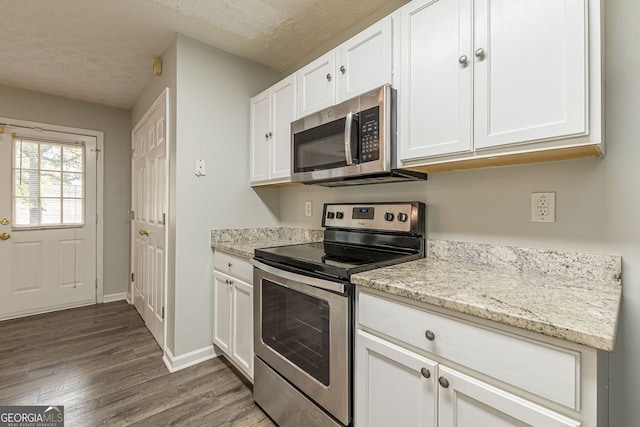 3151 Kingswood Gln, Decatur, GA 30034 - kitchen with stainless steel appliances, dark wood finished floors, a textured ceiling, white cabinets, and light stone countertops