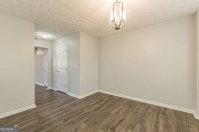 3151 Kingswood Gln, Decatur, GA 30034 - empty room with dark wood finished floors, a chandelier, baseboards, and a textured ceiling
