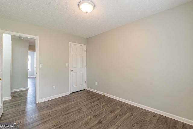 3151 Kingswood Gln, Decatur, GA 30034 - unfurnished bedroom with dark wood-style floors, baseboards, and a textured ceiling