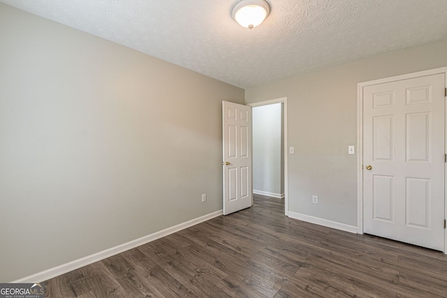 3151 Kingswood Gln, Decatur, GA 30034 - unfurnished bedroom featuring dark wood-type flooring, baseboards, and a textured ceiling