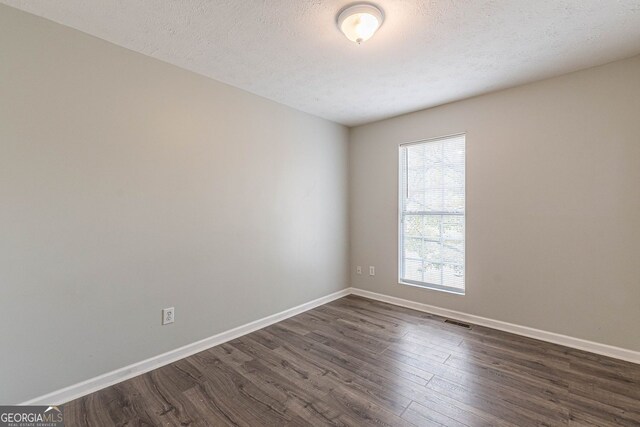 3151 Kingswood Gln, Decatur, GA 30034 - spare room featuring dark wood-type flooring, baseboards, and a textured ceiling