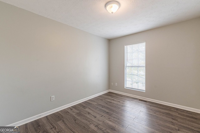 3151 Kingswood Gln, Decatur, GA 30034 - spare room featuring dark wood-type flooring, baseboards, and a textured ceiling