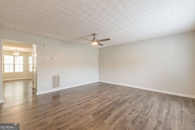 3151 Kingswood Gln, Decatur, GA 30034 - empty room featuring dark wood-style flooring, a ceiling fan, baseboards, and a textured ceiling