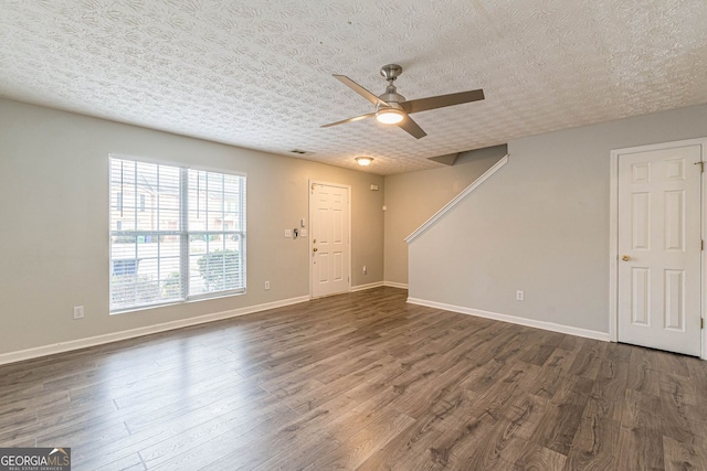3151 Kingswood Gln, Decatur, GA 30034 - unfurnished living room featuring dark wood-type flooring, ceiling fan, baseboards, and a textured ceiling