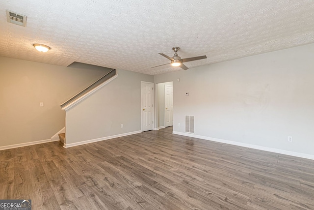 3151 Kingswood Gln, Decatur, GA 30034 - spare room with wood finished floors, a ceiling fan, baseboards, stairway, and a textured ceiling