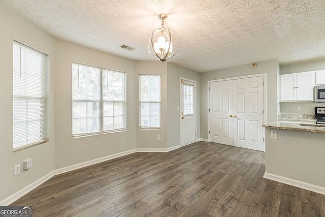 3151 Kingswood Gln, Decatur, GA 30034 - unfurnished dining area with a chandelier, a textured ceiling, dark wood finished floors, and plenty of natural light