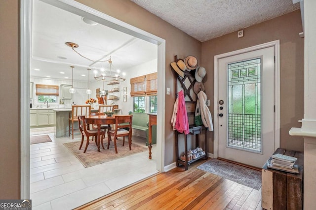 4442 Mclain Cir, Acworth, GA 30101 - foyer entrance with a chandelier, baseboards, and light wood-style flooring