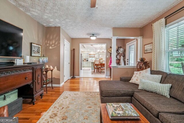 4442 Mclain Cir, Acworth, GA 30101 - living area featuring wood finished floors, a chandelier, and a textured ceiling