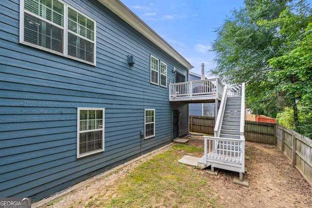 1536 Fenmore St, Lithia Springs, GA 30122 - rear view of property featuring stairs, a fenced backyard, and a deck