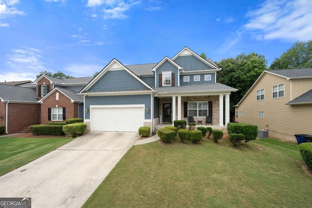 1536 Fenmore St, Lithia Springs, GA 30122 - craftsman-style house with covered porch, a garage, a front yard, concrete driveway, and stone siding