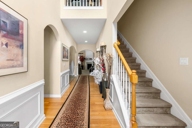 1536 Fenmore St, Lithia Springs, GA 30122 - stairs with arched walkways, wood finished floors, and wainscoting