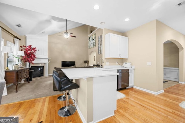 1536 Fenmore St, Lithia Springs, GA 30122 - kitchen featuring arched walkways, a peninsula, dishwashing machine, a ceiling fan, and open floor plan