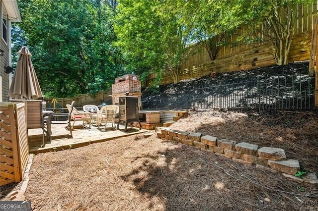 130 Nacoochee Way, Canton, GA 30114 - fenced backyard featuring exterior fireplace, a patio, and outdoor dining area