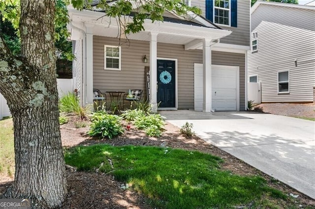 130 Nacoochee Way, Canton, GA 30114 - doorway to property with concrete driveway, an attached garage, and covered porch