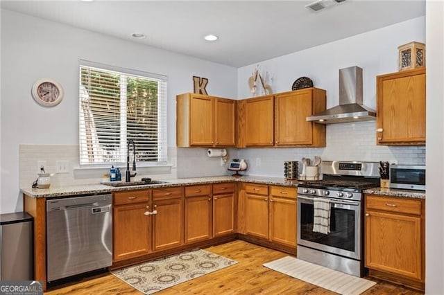 130 Nacoochee Way, Canton, GA 30114 - kitchen with stainless steel appliances, wall chimney exhaust hood, backsplash, light stone countertops, and recessed lighting