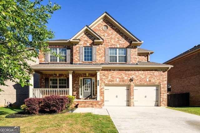 1021 Reddy Farm Rd, Grayson, GA 30017 - view of front of house with driveway, brick siding, covered porch, a garage, and a front yard