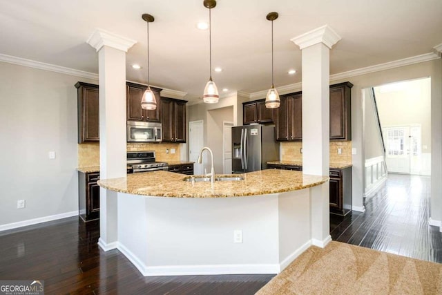 1021 Reddy Farm Rd, Grayson, GA 30017 - kitchen featuring stainless steel appliances, ornate columns, dark brown cabinetry, a large island, and recessed lighting