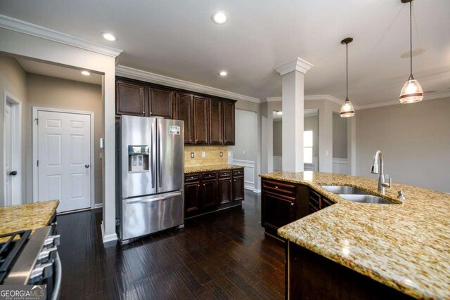1021 Reddy Farm Rd, Grayson, GA 30017 - kitchen featuring stainless steel fridge with ice dispenser, stove, light stone counters, backsplash, and ornamental molding