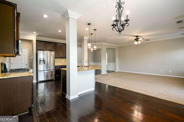 1021 Reddy Farm Rd, Grayson, GA 30017 - kitchen with stainless steel fridge, ceiling fan, crown molding, dark brown cabinetry, and recessed lighting