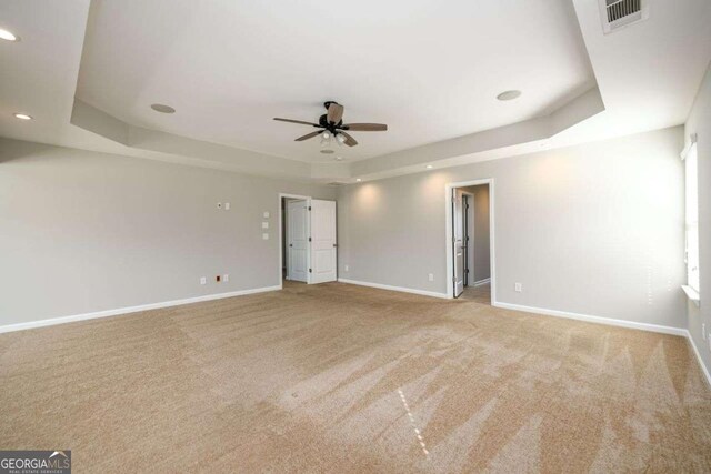 1021 Reddy Farm Rd, Grayson, GA 30017 - carpeted empty room featuring a tray ceiling, a ceiling fan, and recessed lighting