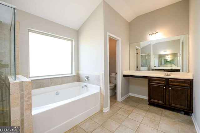 1021 Reddy Farm Rd, Grayson, GA 30017 - bathroom featuring a bath, vanity, vaulted ceiling, tile patterned flooring, and a stall shower