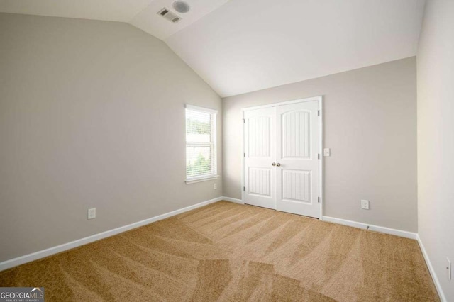 1021 Reddy Farm Rd, Grayson, GA 30017 - unfurnished bedroom featuring vaulted ceiling, carpet, and a closet