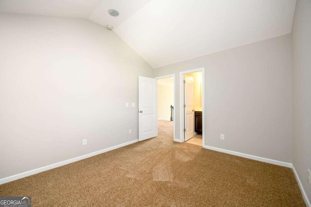 1021 Reddy Farm Rd, Grayson, GA 30017 - unfurnished bedroom with lofted ceiling, light colored carpet, and ensuite bathroom