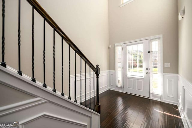 1021 Reddy Farm Rd, Grayson, GA 30017 - foyer entrance with wainscoting, dark wood-style floors, stairway, and a decorative wall