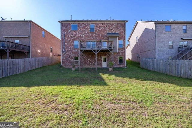 1021 Reddy Farm Rd, Grayson, GA 30017 - back of house featuring brick siding, a fenced backyard, and a deck