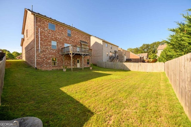 1021 Reddy Farm Rd, Grayson, GA 30017 - back of property featuring brick siding, a fenced backyard, and a wooden deck