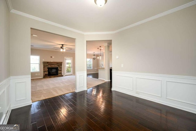 1021 Reddy Farm Rd, Grayson, GA 30017 - unfurnished living room with a fireplace, wood-type flooring, crown molding, ceiling fan, and wainscoting