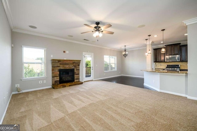 1021 Reddy Farm Rd, Grayson, GA 30017 - unfurnished living room with carpet flooring, crown molding, ceiling fan, a fireplace, and a chandelier