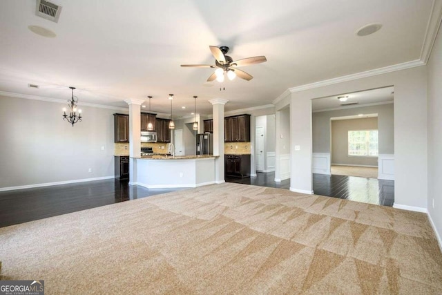 1021 Reddy Farm Rd, Grayson, GA 30017 - unfurnished living room with crown molding, ceiling fan, dark carpet, a chandelier, and dark wood finished floors