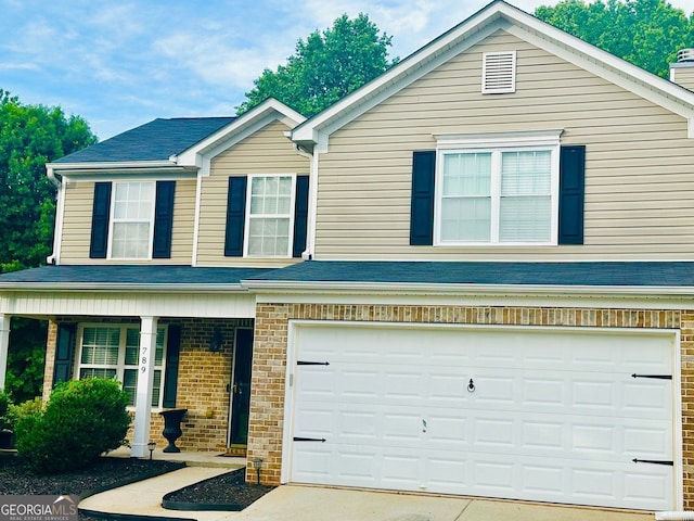 789 Winbrook Dr Unit 1, Mcdonough, GA 30253 - view of front of property with an attached garage, covered porch, concrete driveway, and brick siding