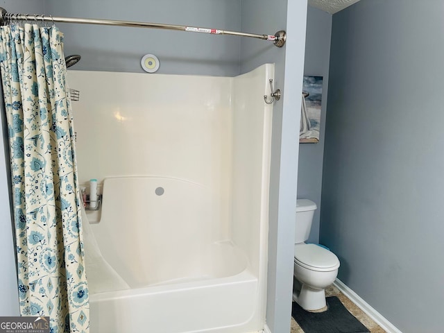 789 Winbrook Dr Unit 1, Mcdonough, GA 30253 - bathroom featuring toilet and shower / bath combination with curtain