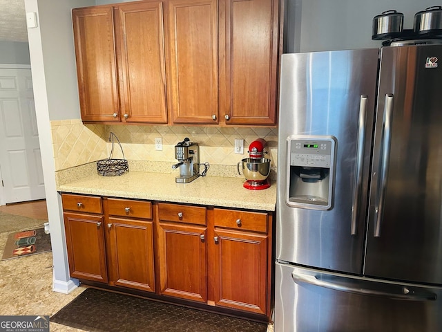 789 Winbrook Dr Unit 1, Mcdonough, GA 30253 - kitchen with stainless steel fridge, tasteful backsplash, and brown cabinets