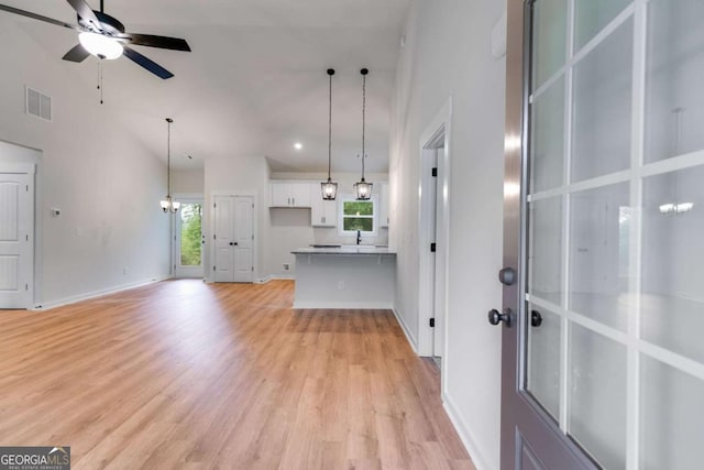560 Coots Lake Rd, Rockmart, GA 30153 - unfurnished living room with healthy amount of natural light, a ceiling fan, light wood-style flooring, recessed lighting, and a towering ceiling