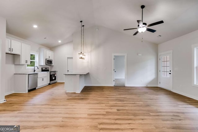 560 Coots Lake Rd, Rockmart, GA 30153 - kitchen with appliances with stainless steel finishes, open floor plan, white cabinets, light wood-style floors, and high vaulted ceiling
