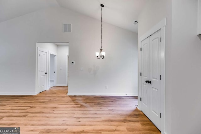 560 Coots Lake Rd, Rockmart, GA 30153 - unfurnished dining area featuring light wood-style flooring, a chandelier, and high vaulted ceiling