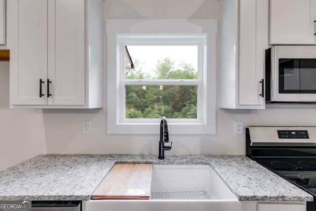 560 Coots Lake Rd, Rockmart, GA 30153 - kitchen with appliances with stainless steel finishes, white cabinetry, and light stone countertops
